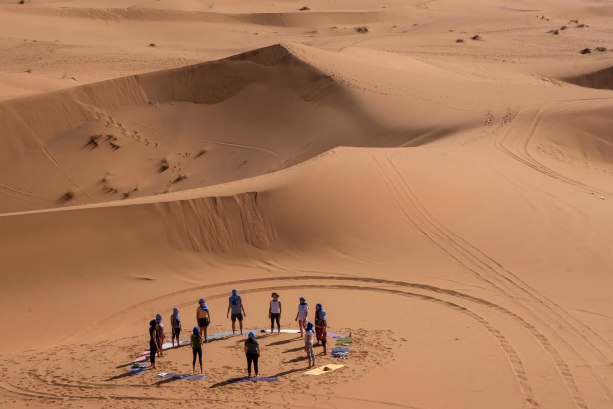 Meditation in desert Morocco sunset dunes yoga retreat